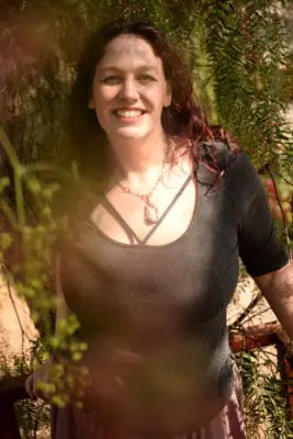 Katie Weatherup seen through pepper tree branches.
