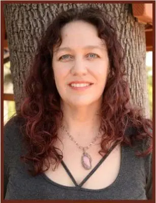 Katie Weatherup smiling with tree in the background.