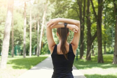 Woman on path in nature moving forward to holistic weight loss